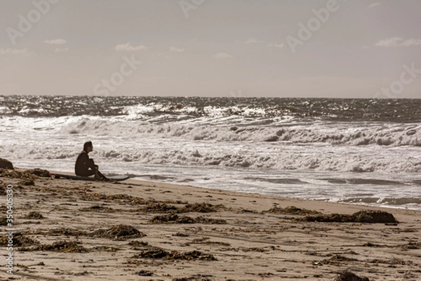 Obraz Surfer contemplates the ocean waves in Southern California, 2018