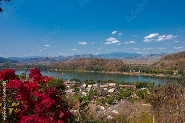 Obraz Luang Prabang old town and Mekong river, Laos, with background of ranges of mountains on a bright sunny day. The town was listed World Heritage Site by UNESCO since 1995.
