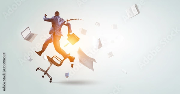 Fototapeta back view of running black businessman with briefcase and falling around office objects