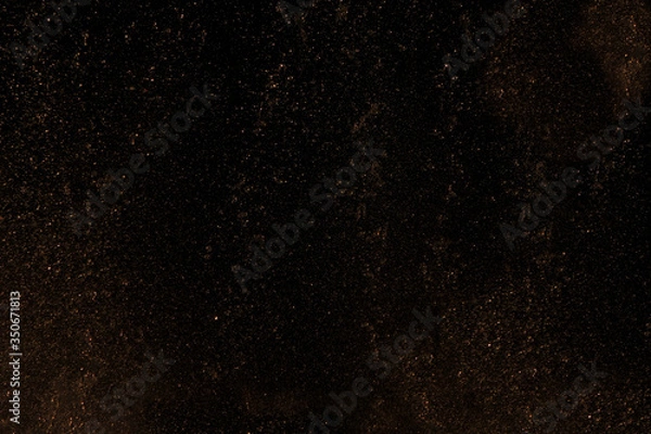 Fototapeta Black abstract background with yellow gold dust.