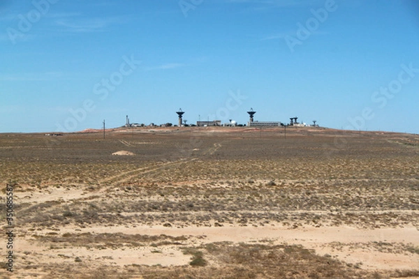 Fototapeta There is a base in the desert. A military or space base far from the city. Desert terrain. The base is under guard.