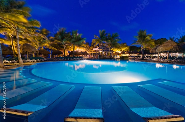 Fototapeta Tropical resort with swimming pool at night