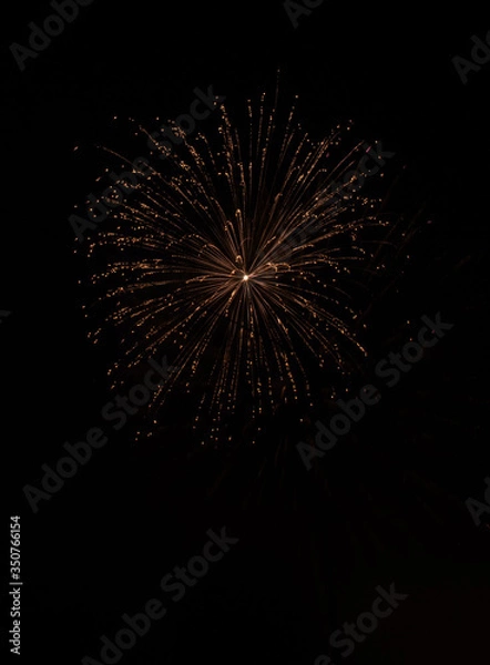 Fototapeta Explosive colorful fireworks display celebrating the fourth of July holiday leaving room for copy..