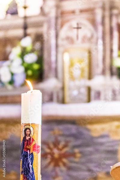 Obraz Paschal candle illuminates the altar and tabernacle of the heart of Jesus