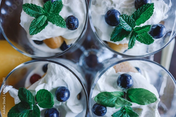 Fototapeta Homemade tiramisu with lemons served on table. Top view of delicious dessert in glass cups.