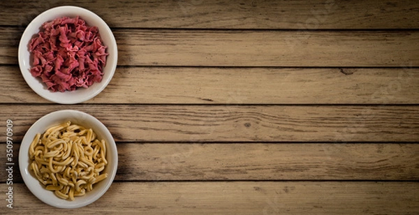 Obraz Fresh italian pasta in a wooden background top view