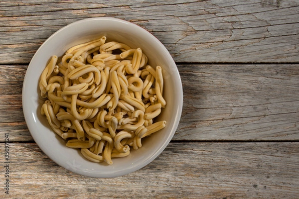 Obraz Fresh italian pasta in a wooden background top view