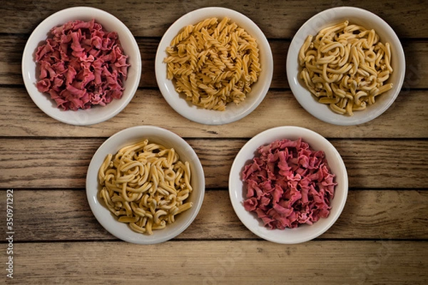 Obraz Fresh italian pasta in a wooden background top view