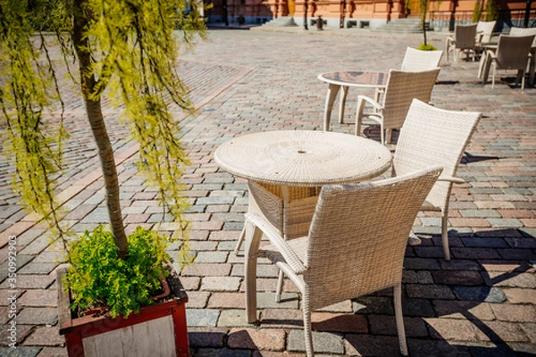 Fototapeta Empty summer terace tables in old town of city. Open air Cafe