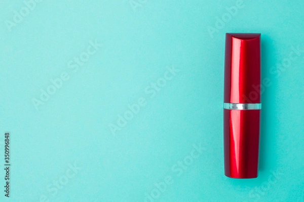 Obraz Red lipstick on a blue background with copyspace.