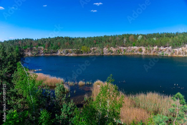 Fototapeta Beautiful view of the flooded granite quarry.