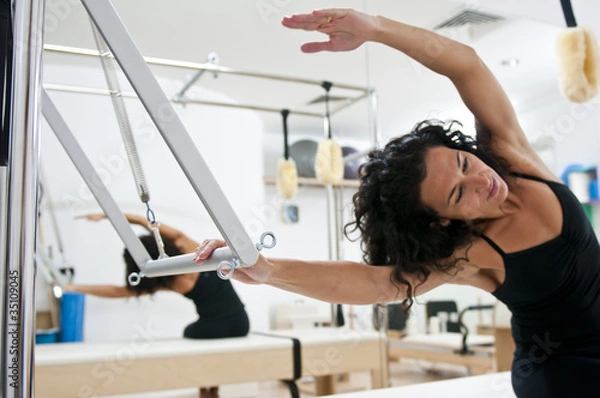 Obraz Attractive young lady doing pilates