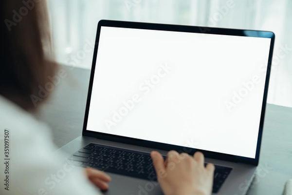 Fototapeta Woman had using laptop white screen and stationery on the table.