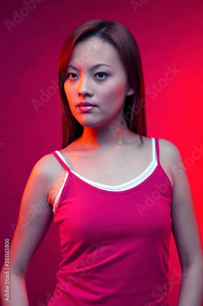 Fototapeta Woman in red top posing on a red background