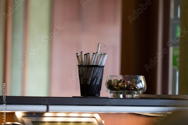 Obraz pens in a cup on a desk