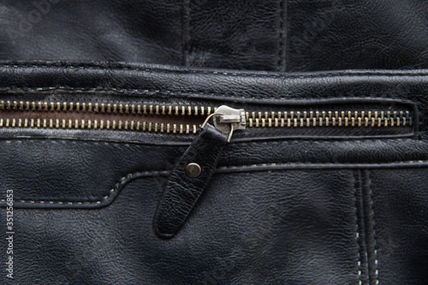 Fototapeta The zipper on the black bag is half buttoned. Concept background with copy space