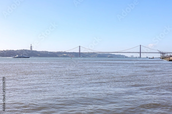 Fototapeta Beautiful iron cross across the river in Portugal. 25th of April bridge in Lisbon