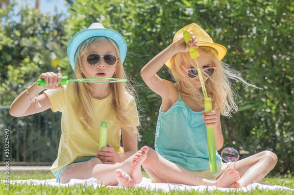 Fototapeta Two sisters playing in the garden, Summertime fun