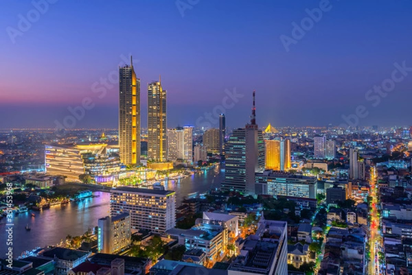 Fototapeta View of Bangkok cityscape. Aerial view of business modern building around the Chao Phraya river in Thailand at twilight time.