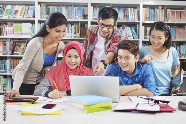 Fototapeta Students studying together in library
