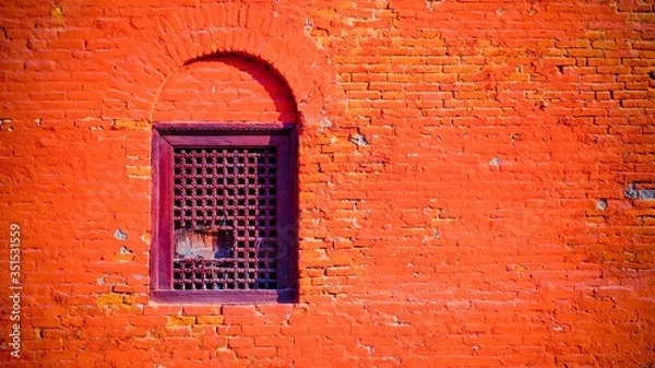 Fototapeta Bright brick wall with wooden windows with holes