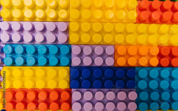 Fototapeta Designer items built like a wall. Color children's designer as background and texture.