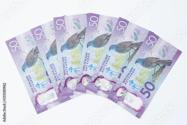 Fototapeta Closeup Stack of New Zealand 50$ Dollar banknotes on white background with copy space for text