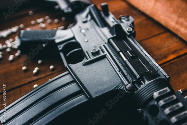 Obraz airsoft assault rifle black on the table, up close