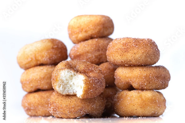 Fototapeta Cinnamon Sugar Mini Donuts in a stack on white background 