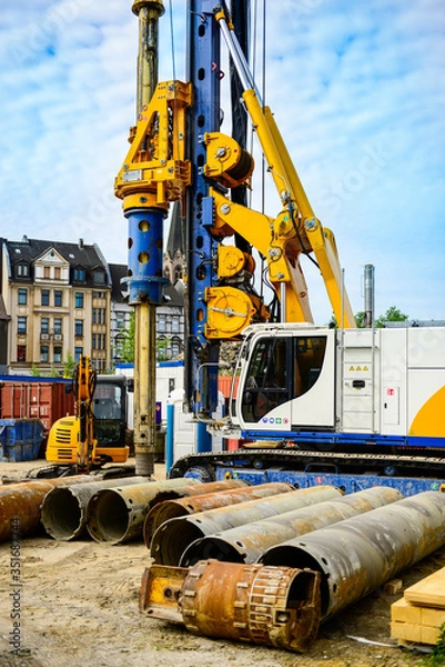 Fototapeta Global project of urban re-development: drilling machine at work on a building site