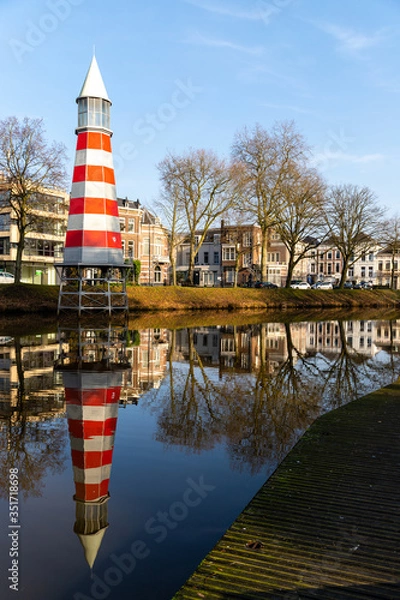 Fototapeta Lighthouse in Breda, reflection in the river.