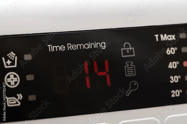Obraz Washing machine display close up, time remaining 14 minutes during washing process. Abstract laundry programming backdrop.