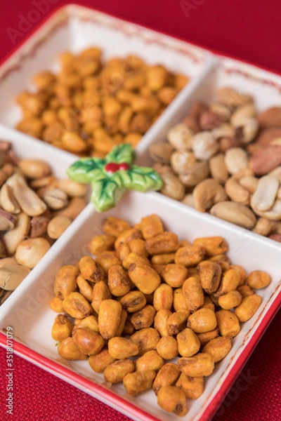 Fototapeta mixed nuts plate on red background. Seed, sauce corn and mixed nuts
