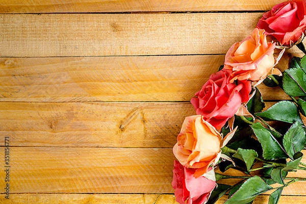 Fototapeta Handmade roses layout on wooden background. Background layout with free text space.