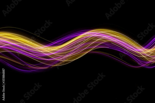 Obraz Long exposure photograph of neon pink and gold colour in an abstract swirl, parallel lines pattern against a black background. Light painting photography.