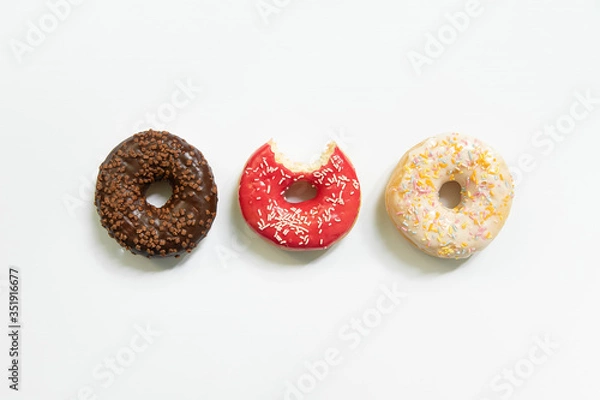 Fototapeta Appetizing sweet donut on a white background. Top view