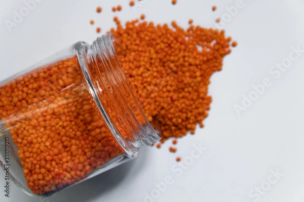 Fototapeta Red lentils isolated on white background. Top view.