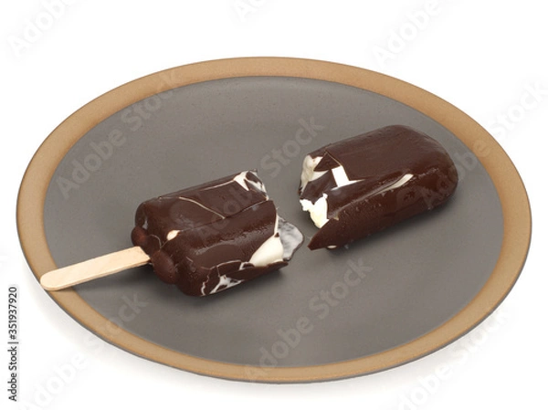 Fototapeta Ice cream covered with chocolate, broken in a plate