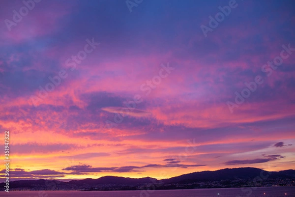 Fototapeta Sunset sky full of clouds with warm tones