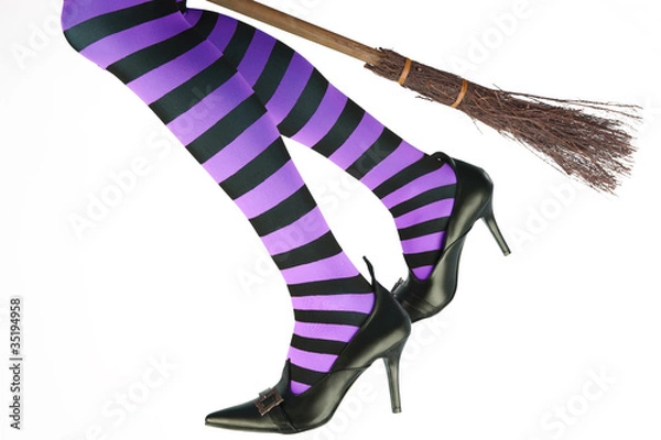 Fototapeta Stripey legged witch flying on a broomstick.