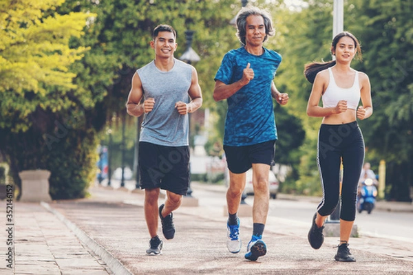 Fototapeta Runners. Young people  running on a city path