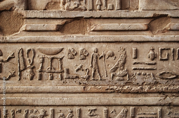 Fototapeta Ancient hieroglyph and relief on the wall of a Temple in Egypt
