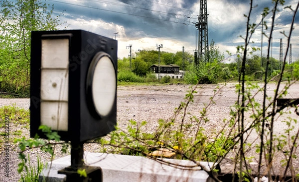 Fototapeta Old track switch on the railway track, Signal box in the background