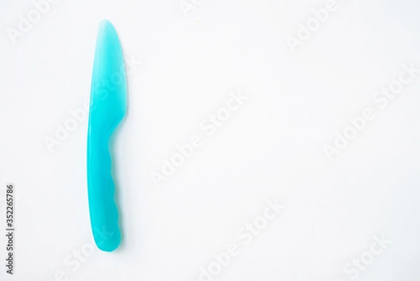 Obraz plastic knife blue white background top view