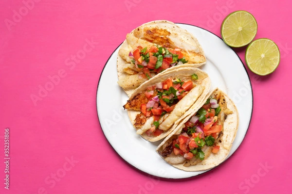 Fototapeta Mexican fish tacos also called Baja with fresh sauce on pink background