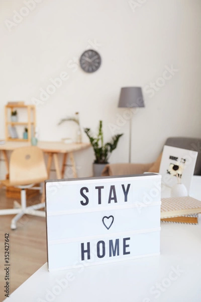 Fototapeta Image of poster with text Stay home in the living room at home