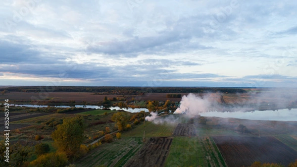 Obraz smoke in the field. aerial view