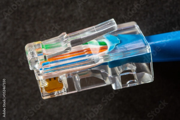 Obraz Network cable on black background.