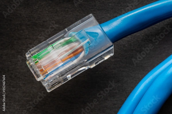 Obraz Network cable on black background.