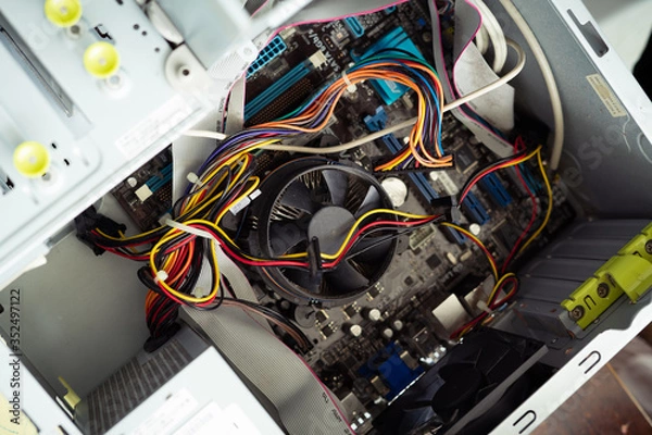 Fototapeta Cleaning and fixing the personal computer (PC) with a vacuum cleaner. Computer service and maintainance.